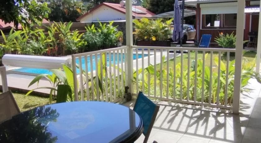 The white-railed terrace at Entr'Deux Gones overlooking the garden and pool