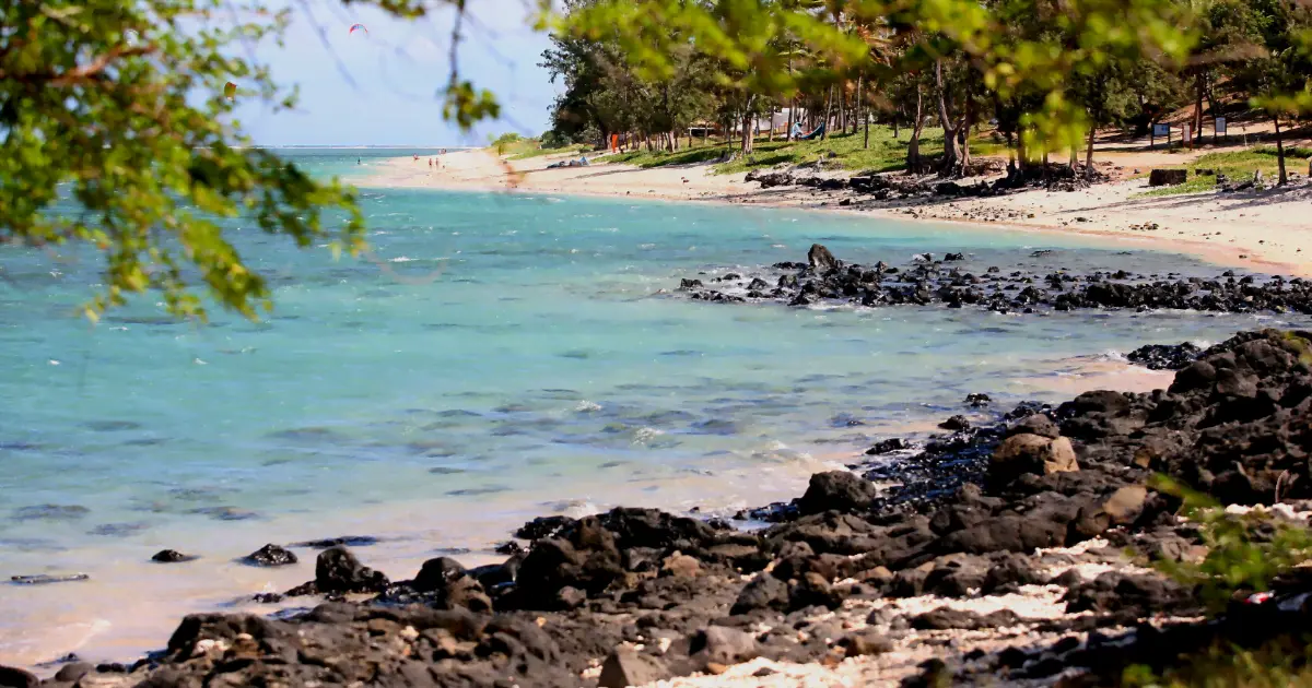 Plage du Trou d'Eau avec lagon turquoise, filaos et roches basaltiques