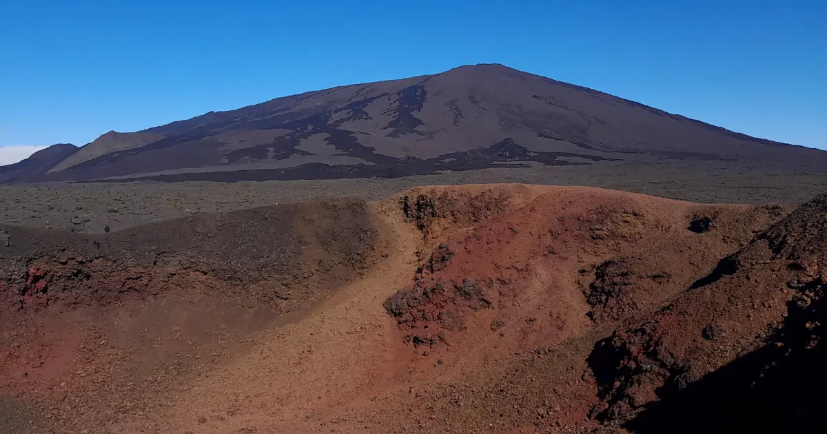 Panoramic view of Piton de la Fournaise with the red crater in the foreground and the summit cone