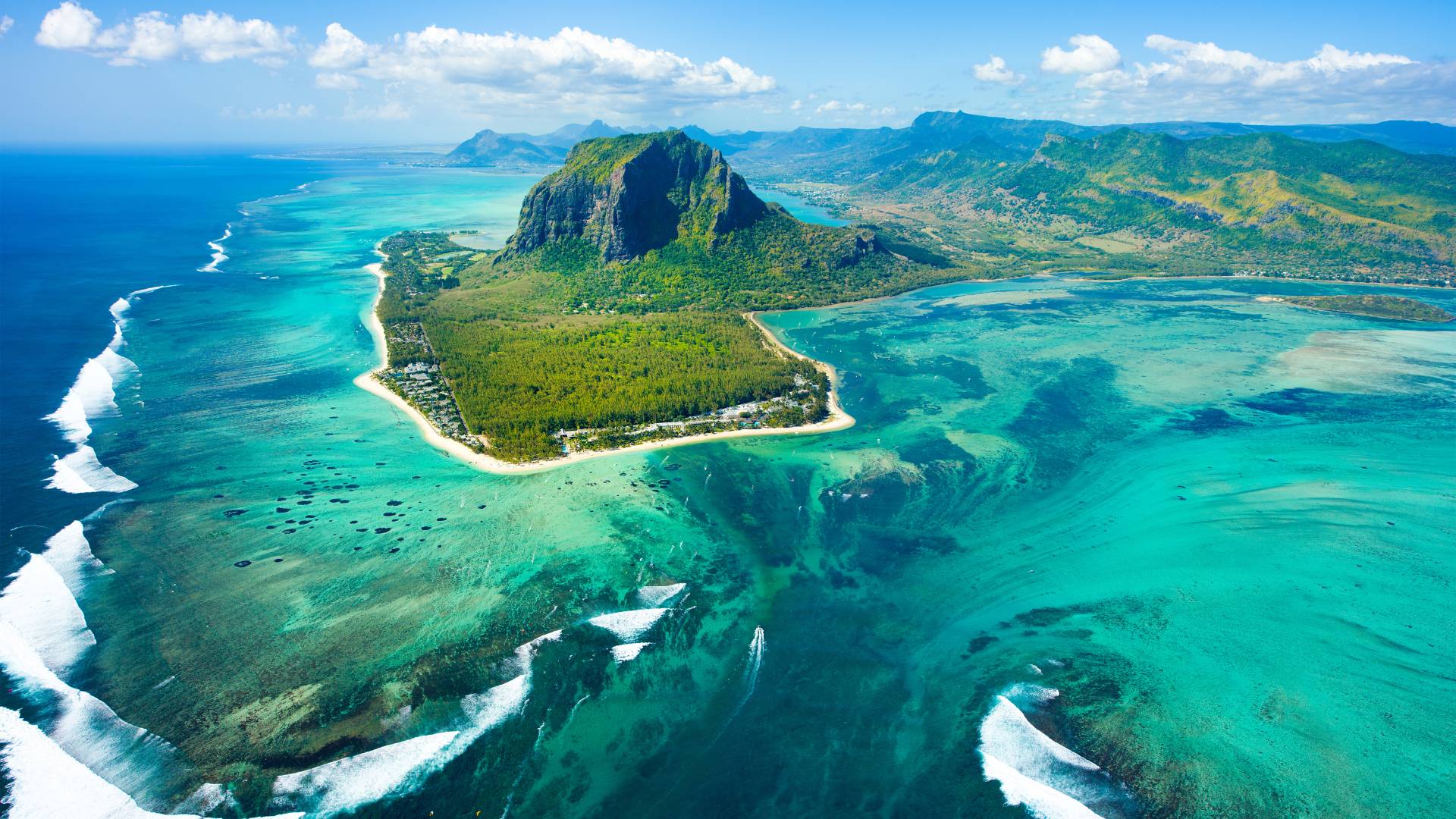 Aerial view of Le Morne Brabant in Mauritius: a turquoise lagoon, a coral reef, a mountainous headland at the heart of a spectacular reef