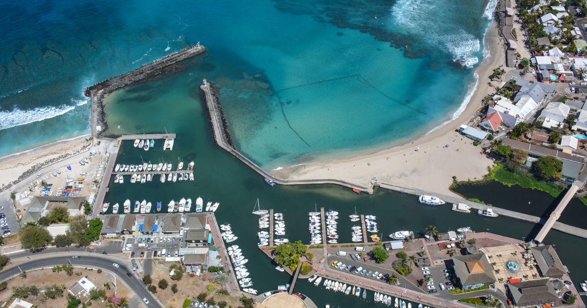 Aerial view of Saint-Gilles-les-Bains marina, its breakwaters and Roches Noires beach