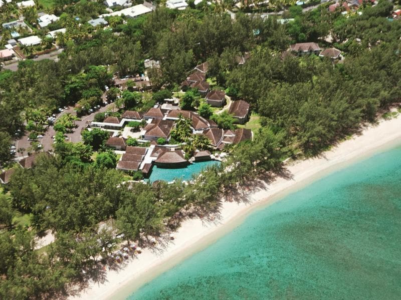 Aerial view of LUX* Saint Gilles: Creole villas among casuarinas, the pool and L'Hermitage beach on a turquoise lagoon