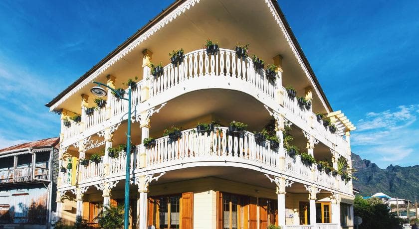 The Tsilaosa's facade in Cilaos: a white Creole house with ornate balconies and flower boxes