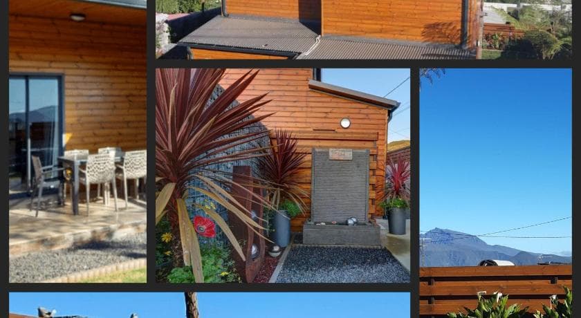 Logement en bois de L'Instant d'Évasion, jardin minéral planté de cordylines, montagnes au loin