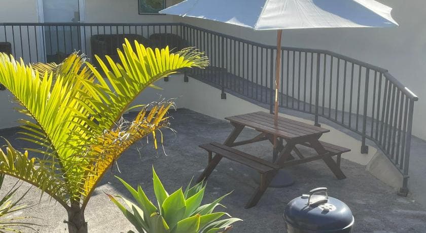 El Dorado's terrace with a picnic table, a parasol and railings