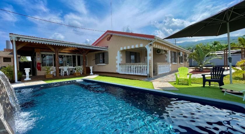 The Creole-style house at La Kaz Baz ' île behind its pool and lawn