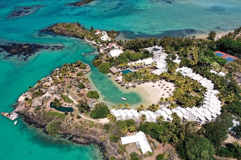 Aerial view of Paradise Cove on its peninsula, around a turquoise cove