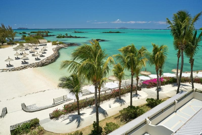Lagoon Attitude's beach and lagoon from above, palms, loungers and islets offshore